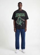 Model wearing black Senegal AFCON graphic T-shirt by MADEBYFUTBOL