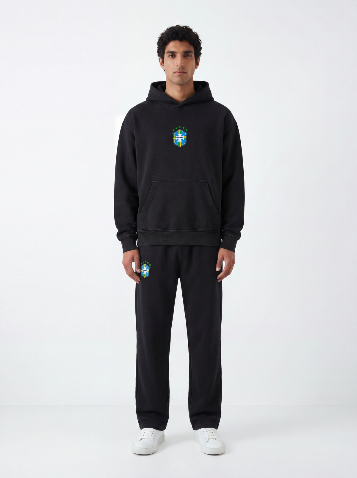 Model wearing black Brazil hoodie and matching sweatpants by MADEBYFUTBOL