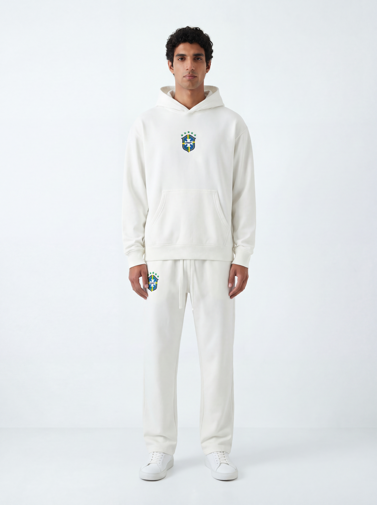 Model wearing white Brazil hoodie and matching sweatpants by MADEBYFUTBOL